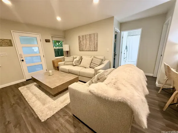 a living room with couches and a flat screen tv