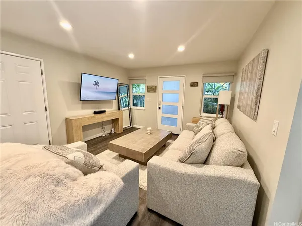 a living room with furniture and a flat screen tv