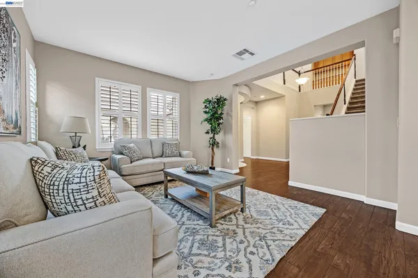 a living room with furniture and wooden floor