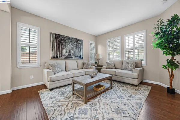 a view of a dining room with furniture a chandelier and wooden floor