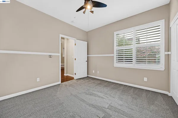 a bathroom with a granite countertop sink a toilet and shower