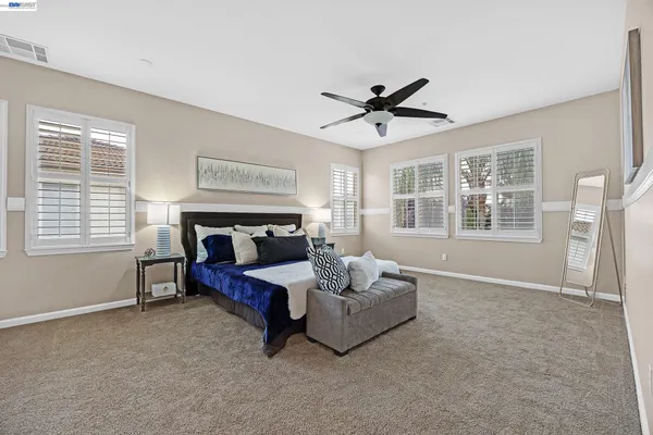 a bathroom with a sink double vanity granite tub and a mirror