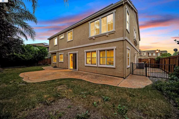 a view of a house with yard and a garden