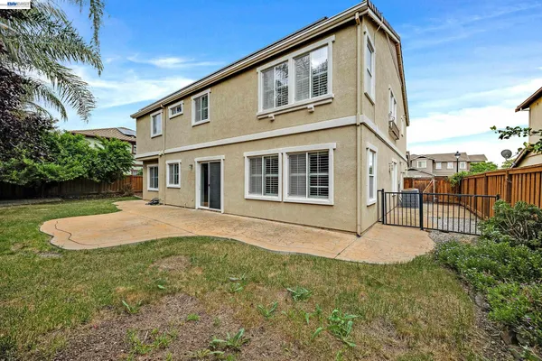 an aerial view of a house with garden space and a fountain