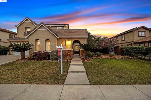 a front view of a house with garden