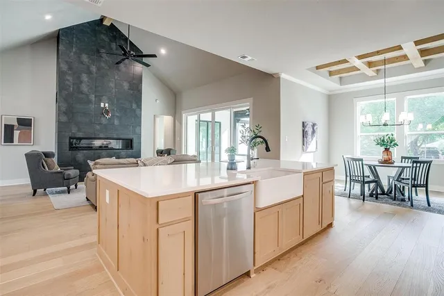 a large kitchen with kitchen island a sink table and chairs