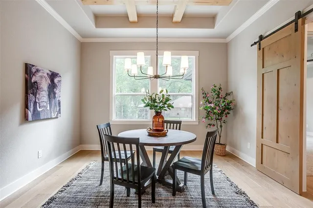 a dining room with furniture window and wooden floor