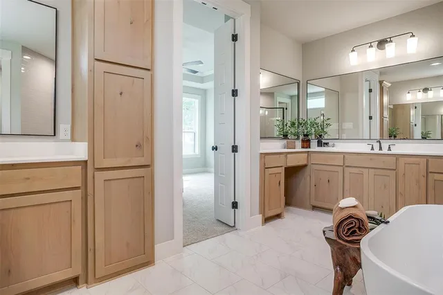 a kitchen with white cabinets and refrigerator