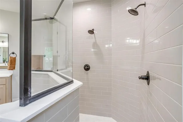 a bathroom with a tub and shower