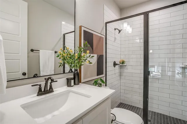 a bathroom with a sink toilet and shower