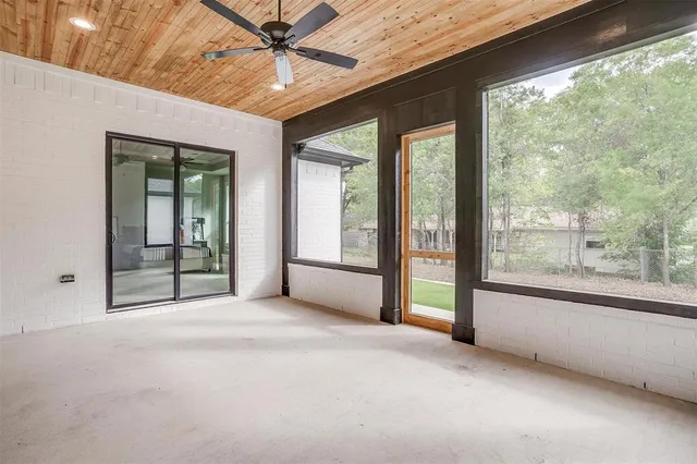 a view of an empty room with a fireplace and a large window