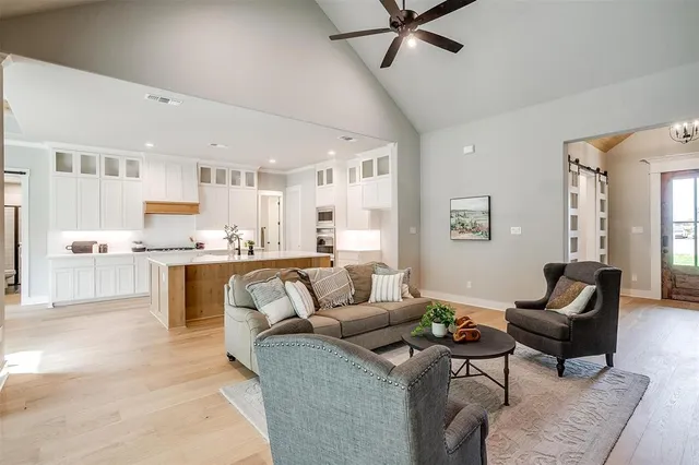 a living room with furniture and kitchen view