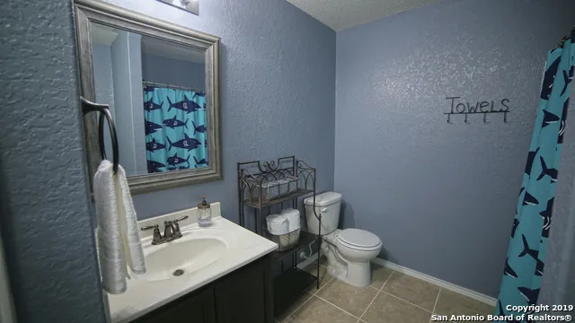 a bathroom with a sink toilet and mirror
