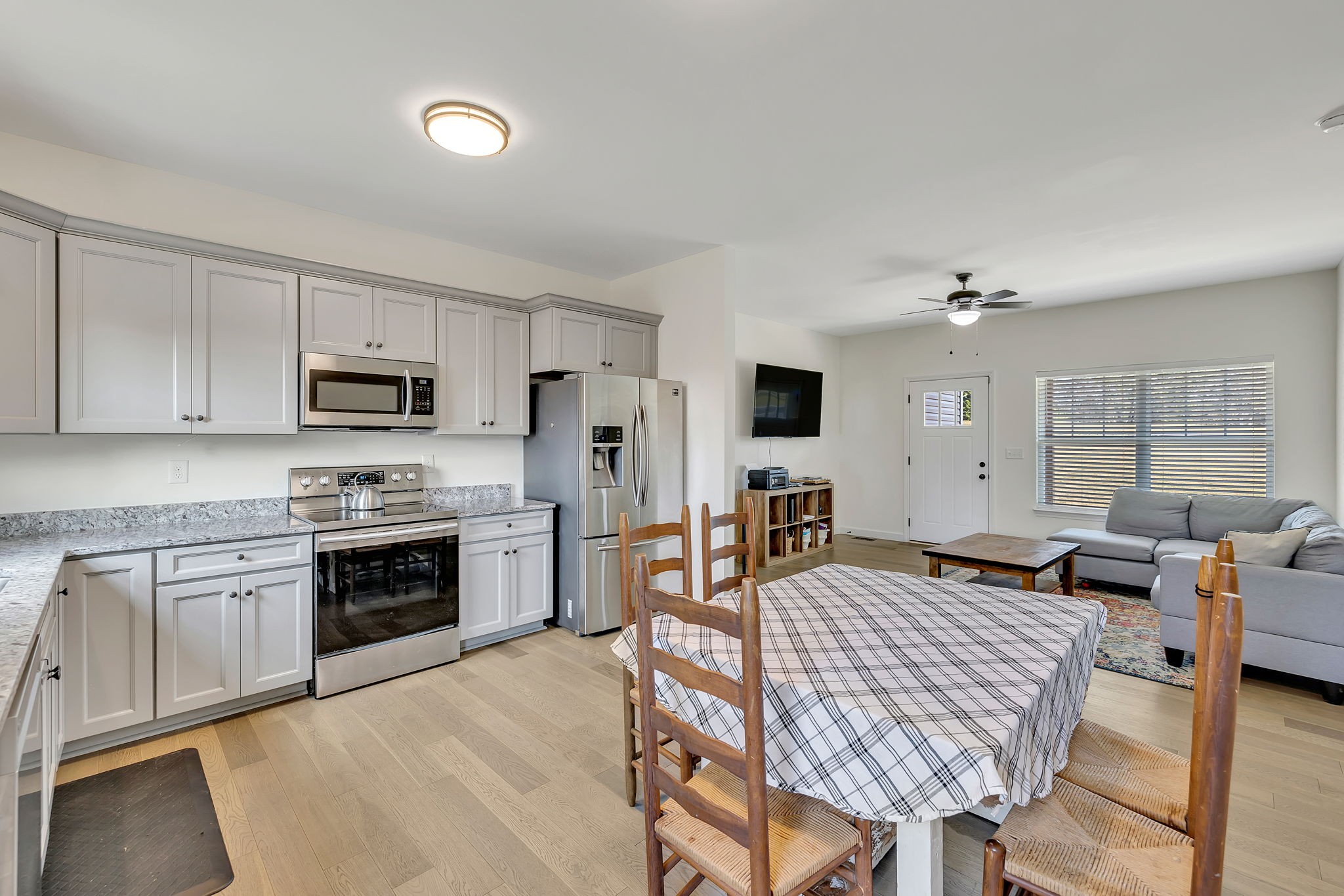 541 Murrell Road Dickson, TN 37055 - Photo 12 of 29 a open kitchen with stainless steel appliances granite countertop a kitchen island hardwood floor sink stove dining table and chairs