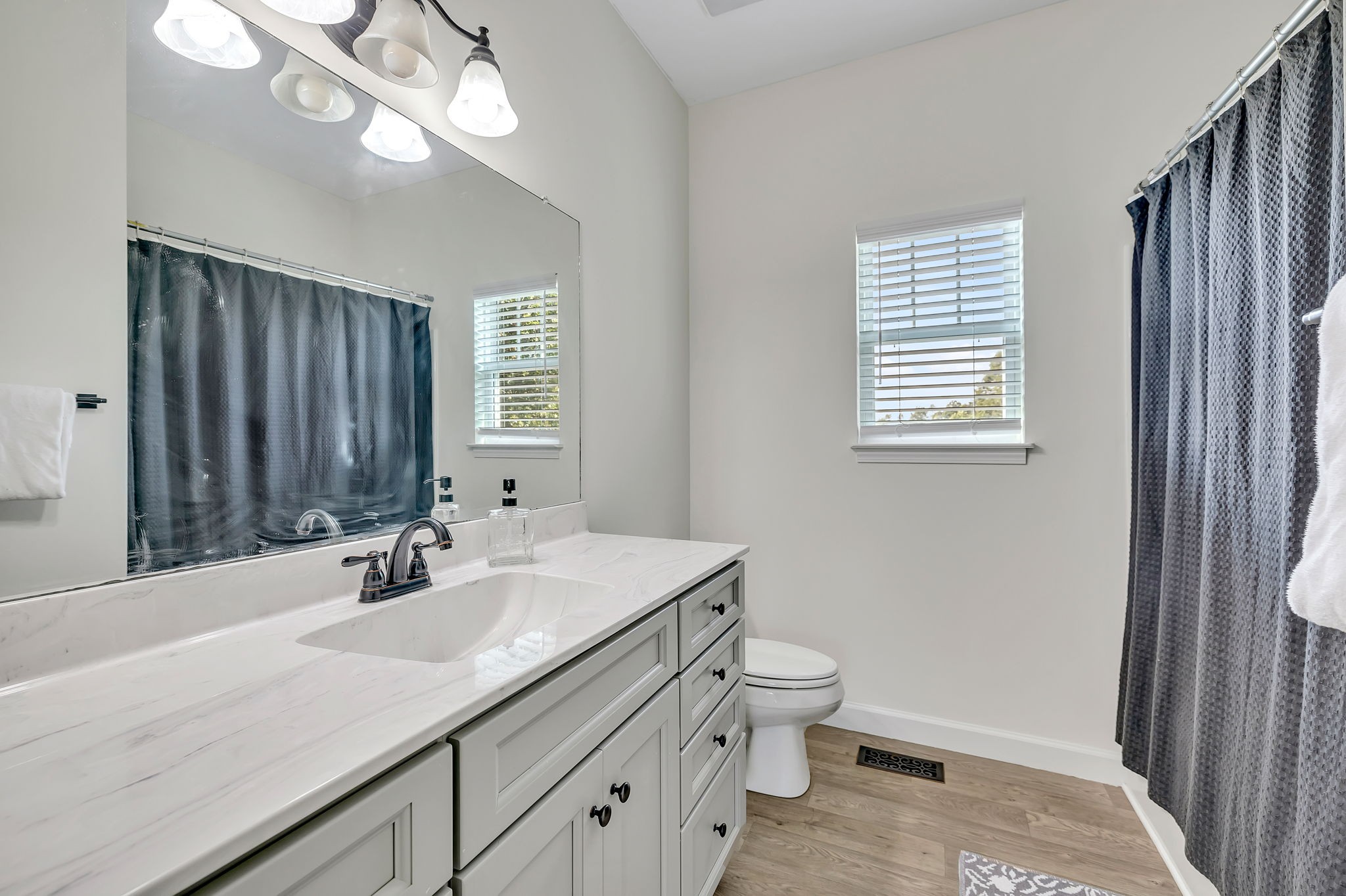 541 Murrell Road Dickson, TN 37055 - Photo 15 of 29 a bathroom with a double vanity sink a toilet and a mirror