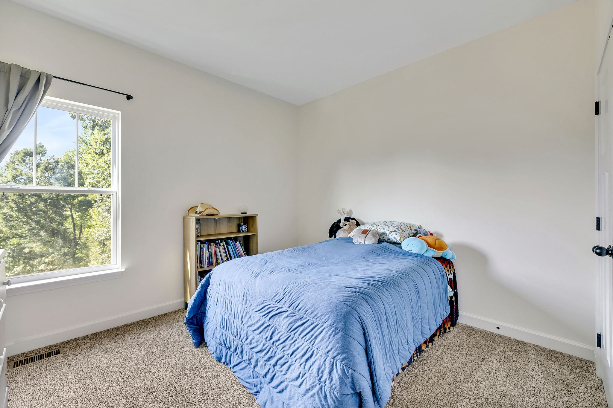 541 Murrell Road Dickson, TN 37055 - Photo 16 of 29 a bed sitting in a bedroom next to a window