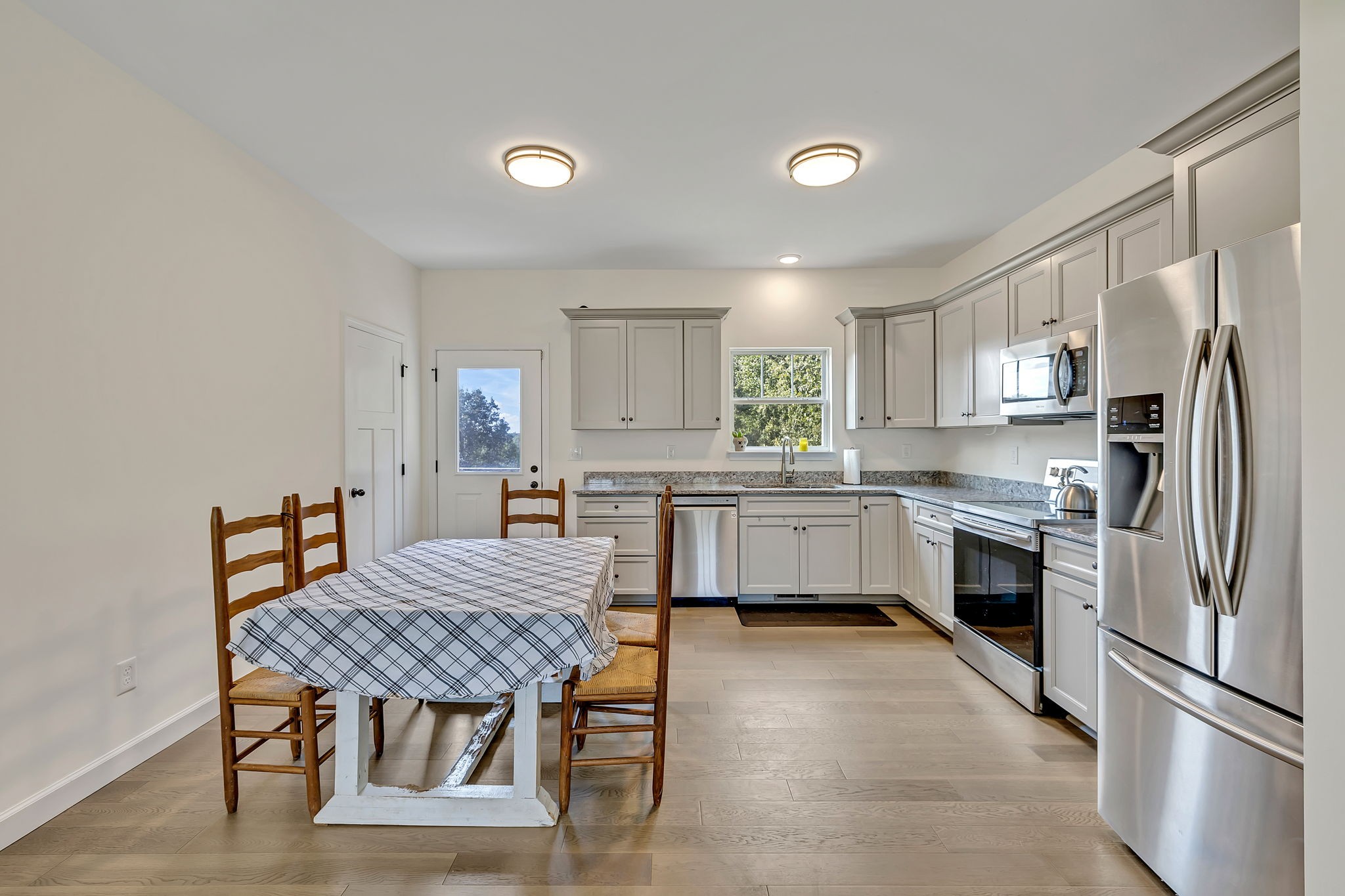 541 Murrell Road Dickson, TN 37055 - Photo 8 of 29 a kitchen with a table chairs refrigerator and window