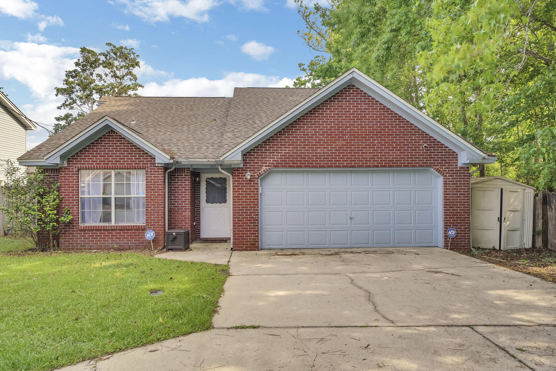 504 Easy Street Fort Walton Beach, FL 32547 - Photo 1 of 21 a front view of a house with a garden and yard