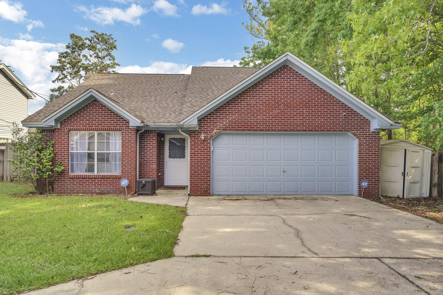 504 Easy Street Fort Walton Beach, FL 32547 - Photo 2 of 21 a front view of a house with a yard and garage