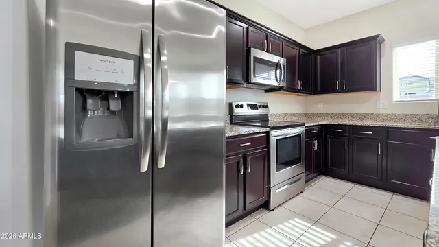 a kitchen with stainless steel appliances granite countertop a stove top oven a sink and dishwasher