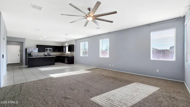 a view of kitchen with furniture and a ceiling fan