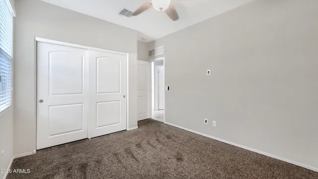 an empty room with a ceiling fan