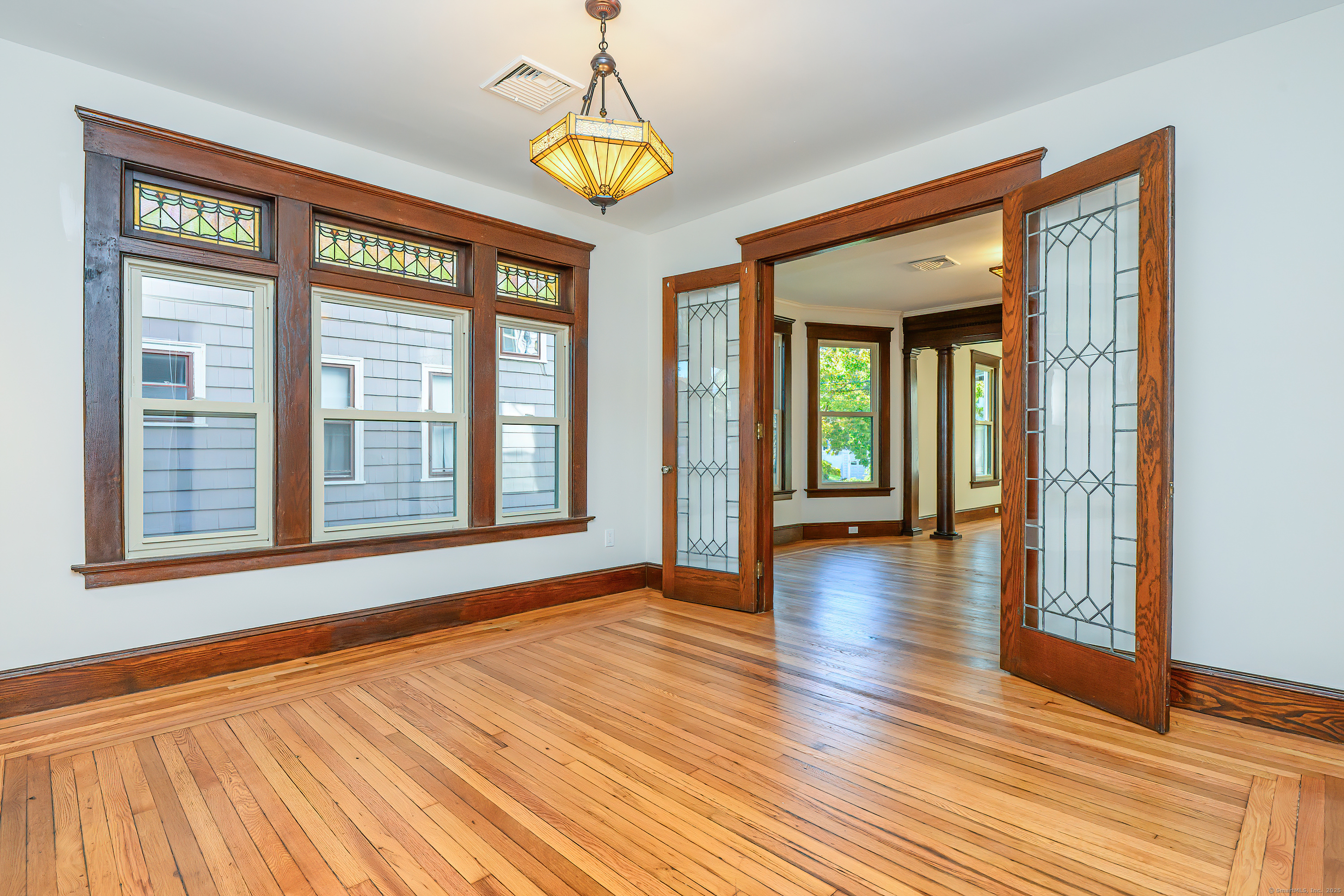 a view of an room with wooden floor and chandelier