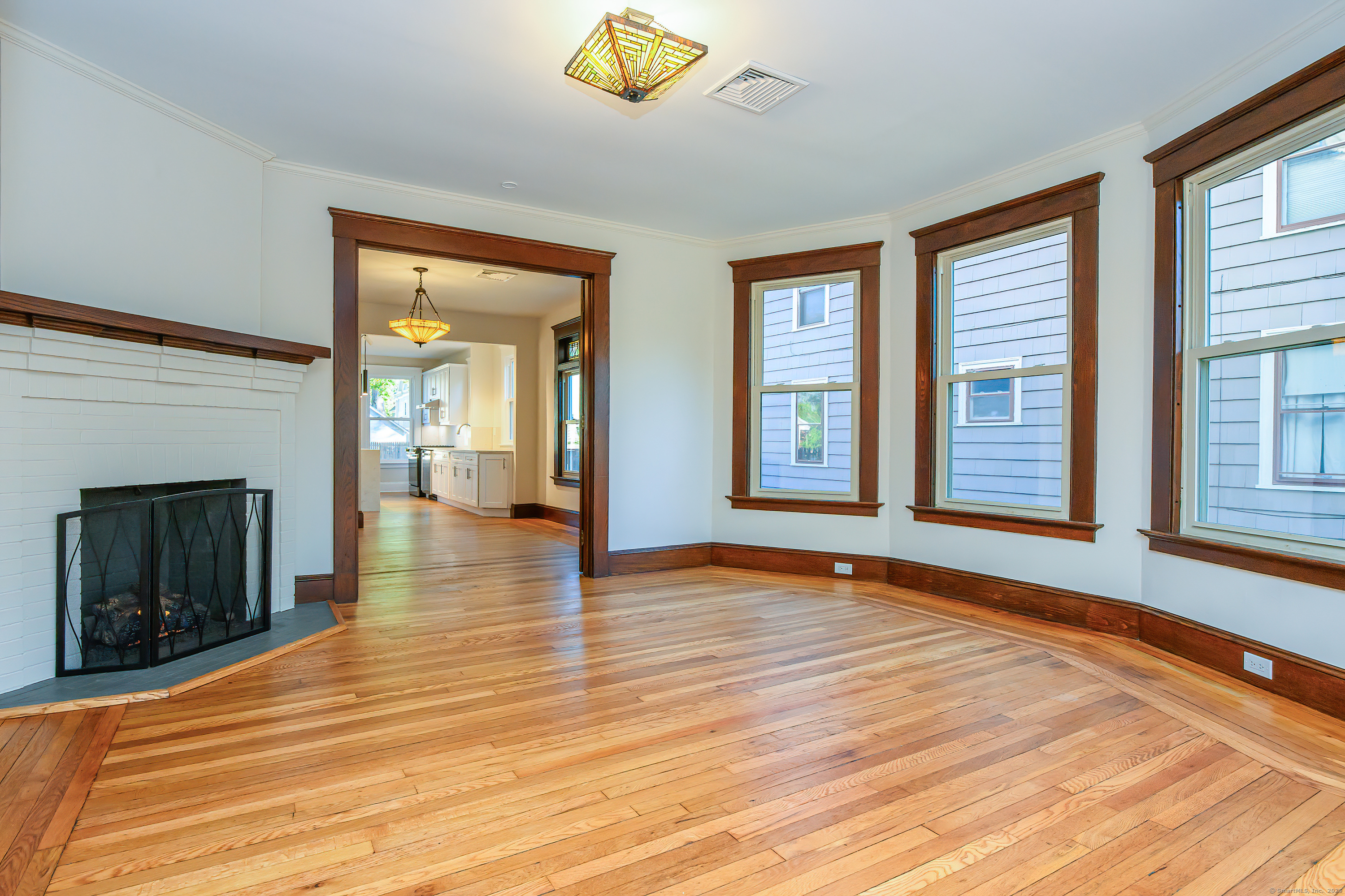 27 Hubinger Street, Unit 1 New Haven, CT 06511 - Photo 14 of 36 a view of an empty room with wooden floor and a window