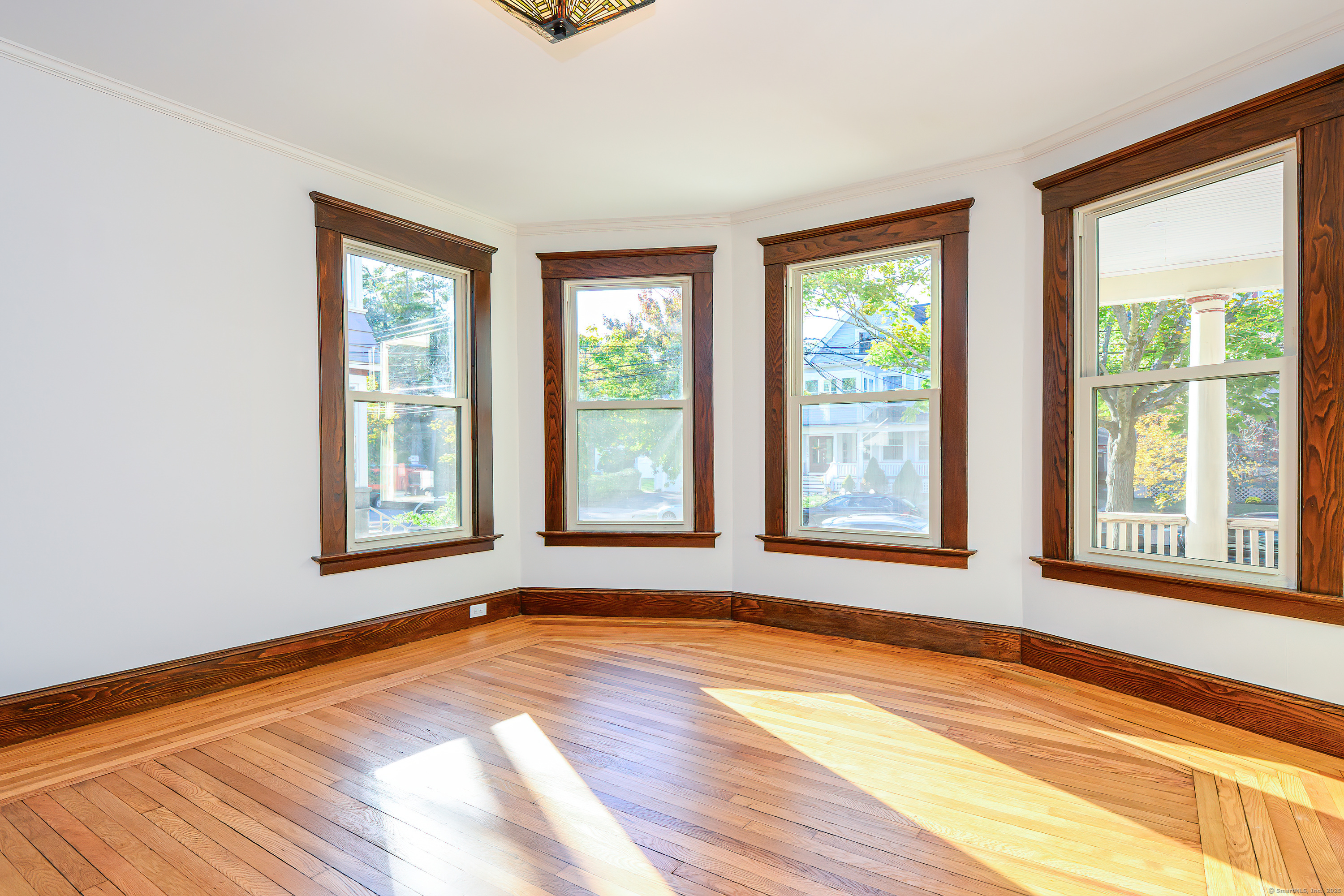 27 Hubinger Street, Unit 1 New Haven, CT 06511 - Photo 16 of 36 a view of an empty room with wooden floor and a window