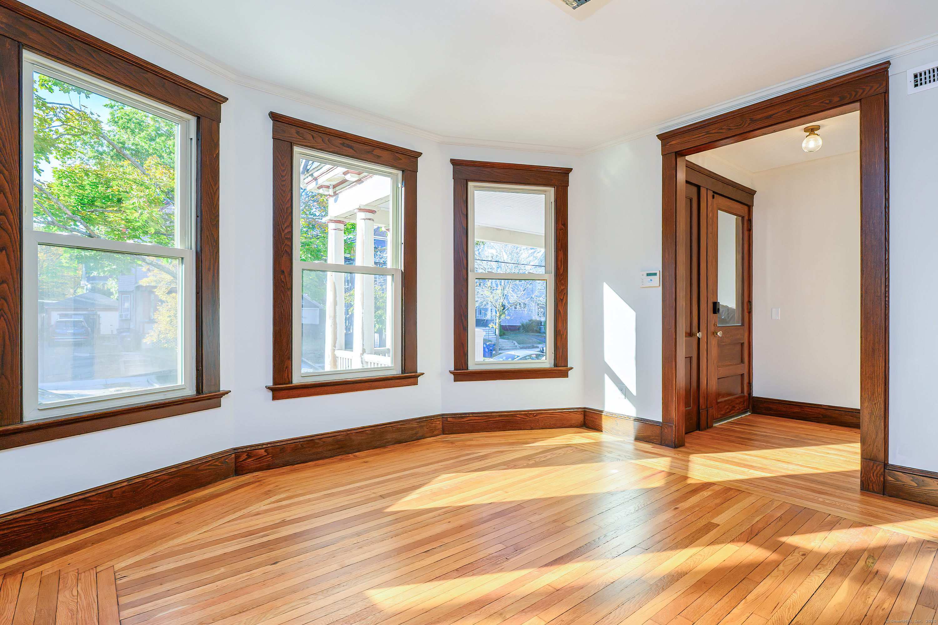 27 Hubinger Street, Unit 1 New Haven, CT 06511 - Photo 17 of 36 a view of an empty room with wooden floor and a window