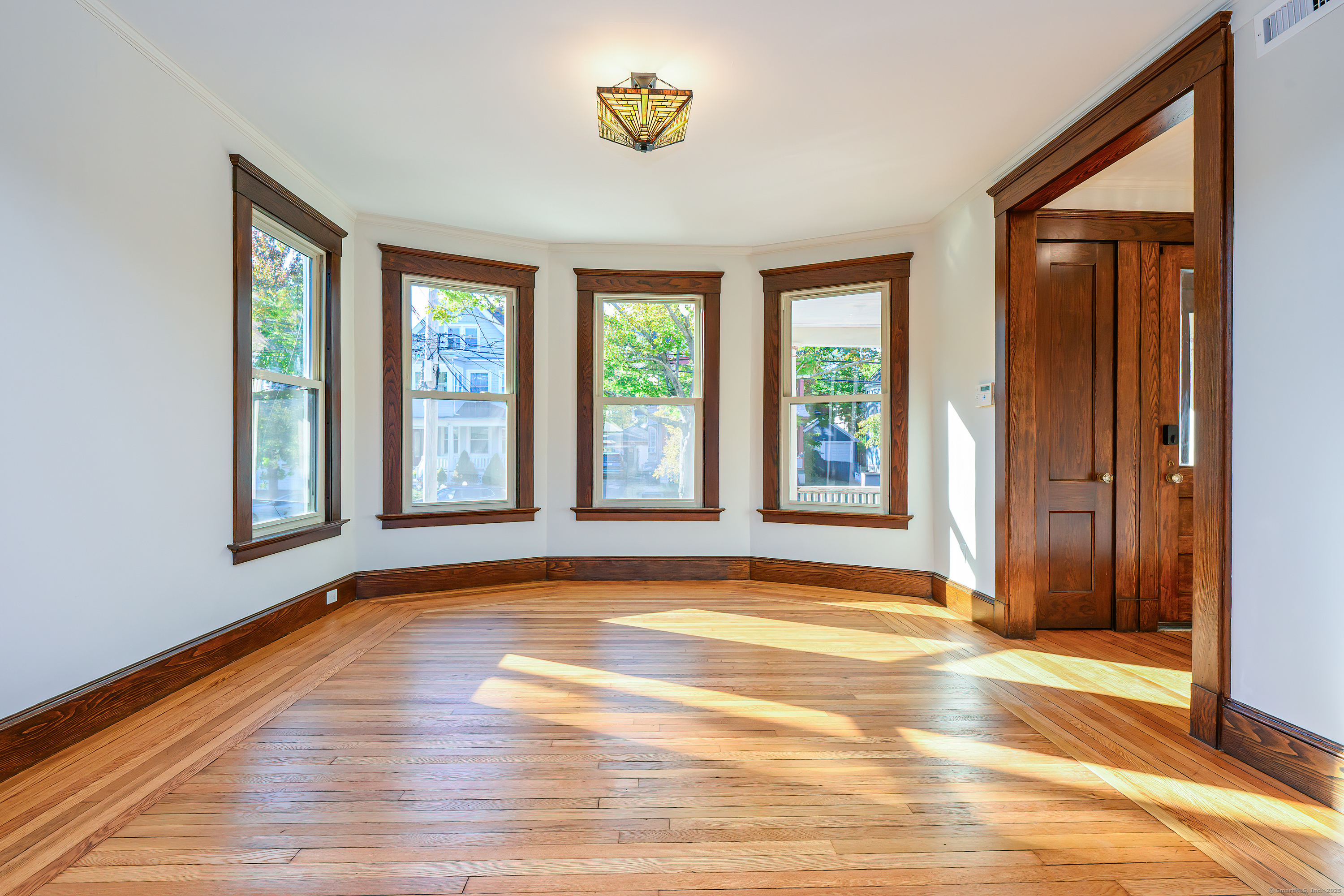 27 Hubinger Street, Unit 1 New Haven, CT 06511 - Photo 18 of 36 a view of an empty room with window and a kitchen