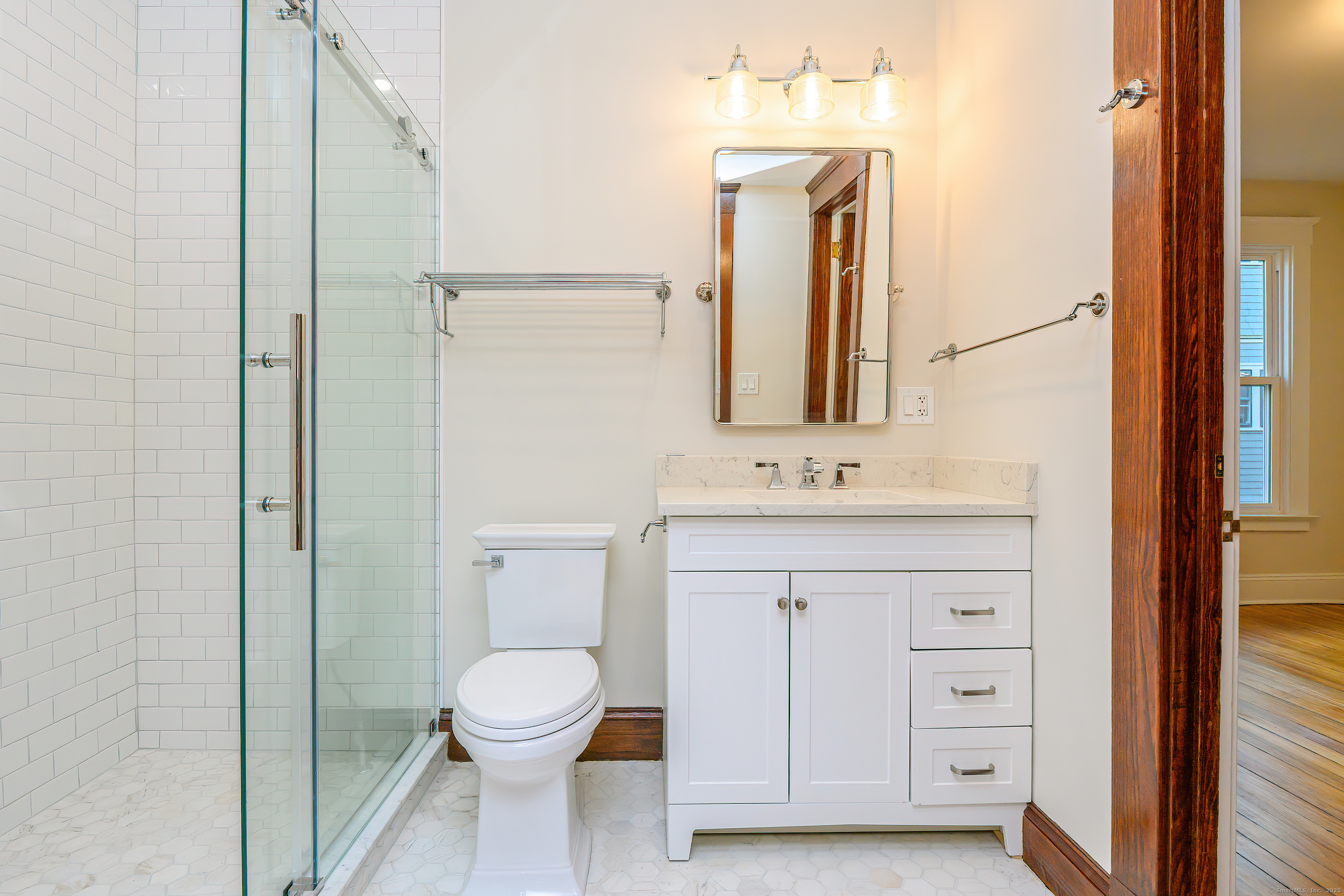 27 Hubinger Street, Unit 1 New Haven, CT 06511 - Photo 20 of 36 a bathroom with a sink a toilet and a mirror