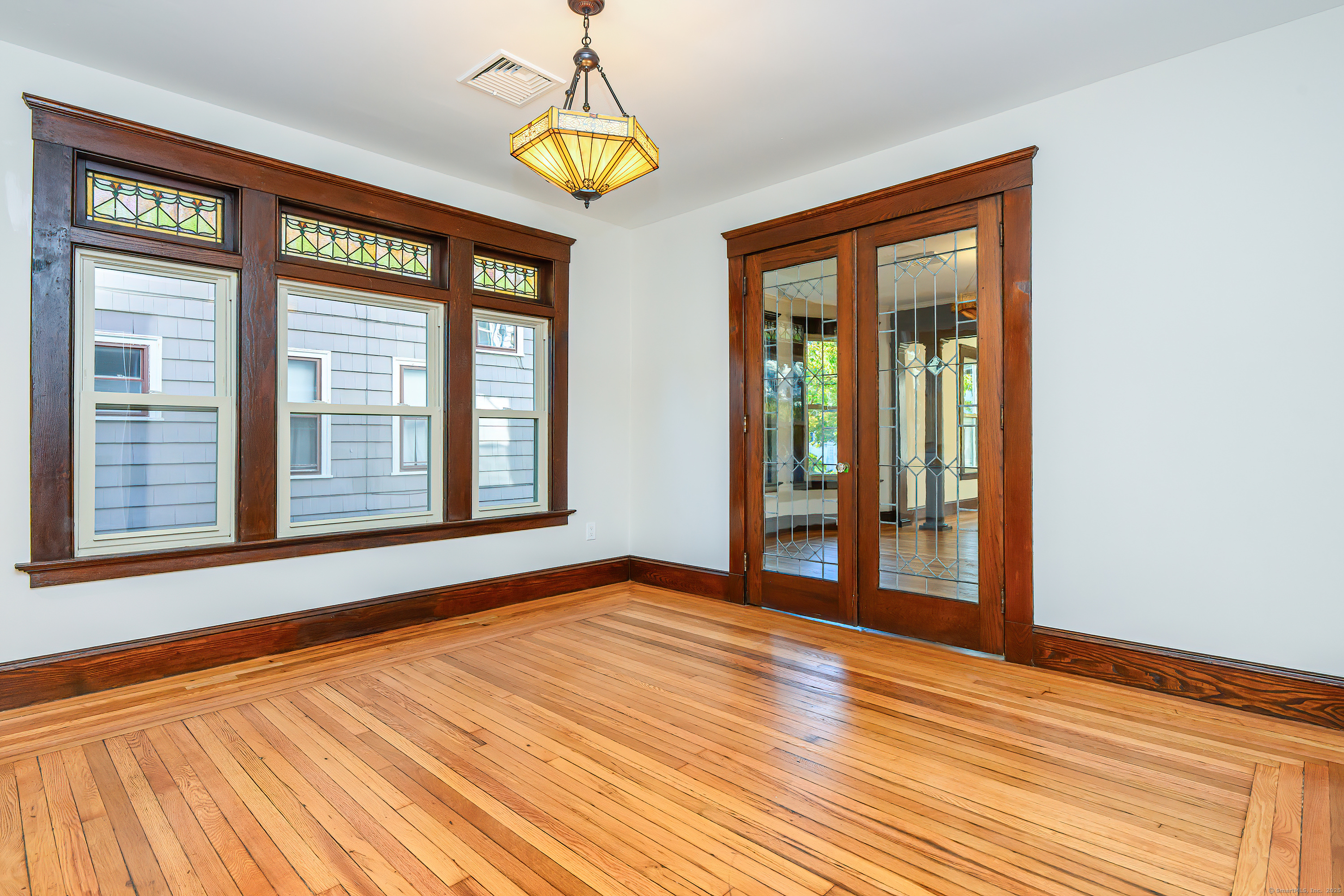 27 Hubinger Street, Unit 1 New Haven, CT 06511 - Photo 2 of 36 a view of an empty room with a window and wooden floor