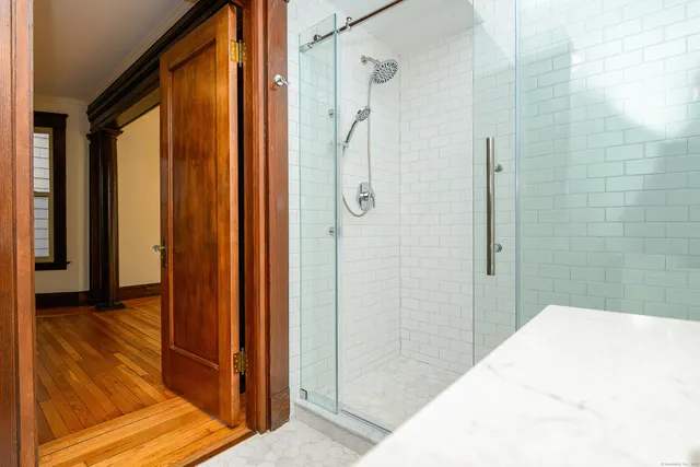 a bathroom with a shower and a tub