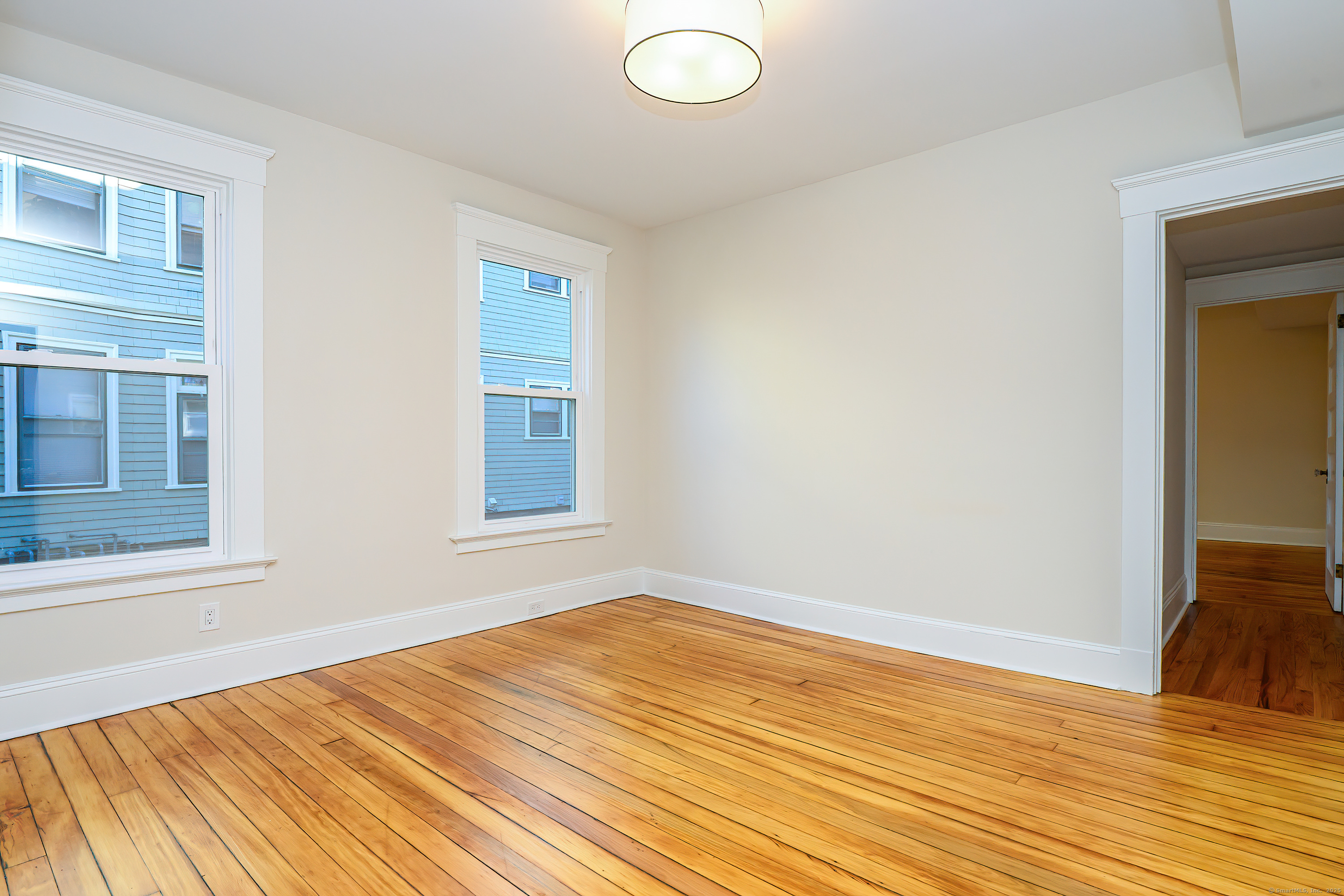 27 Hubinger Street, Unit 1 New Haven, CT 06511 - Photo 23 of 36 a view of empty room with wooden floor and fan