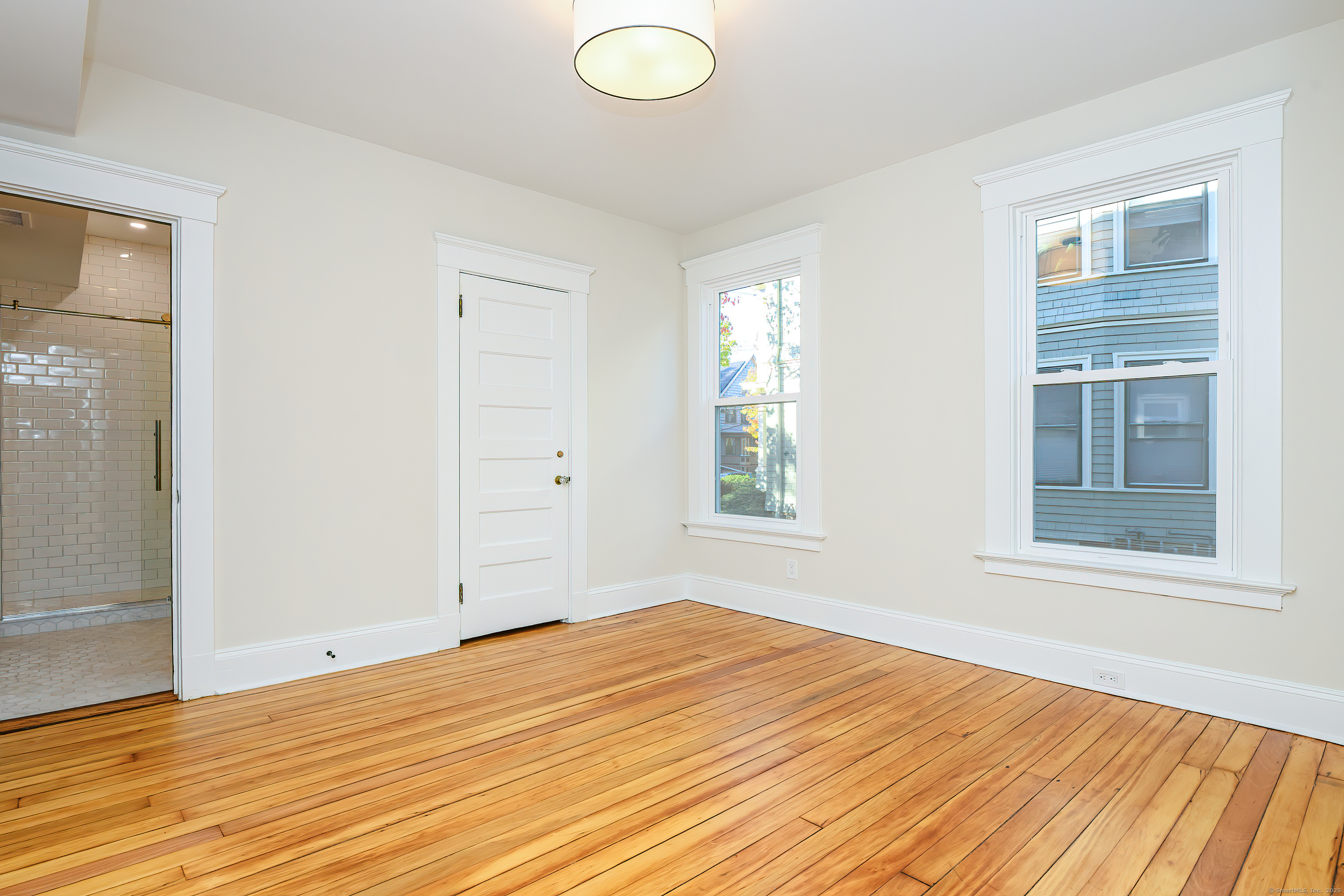27 Hubinger Street, Unit 1 New Haven, CT 06511 - Photo 25 of 36 a view of empty room with wooden floor and fan
