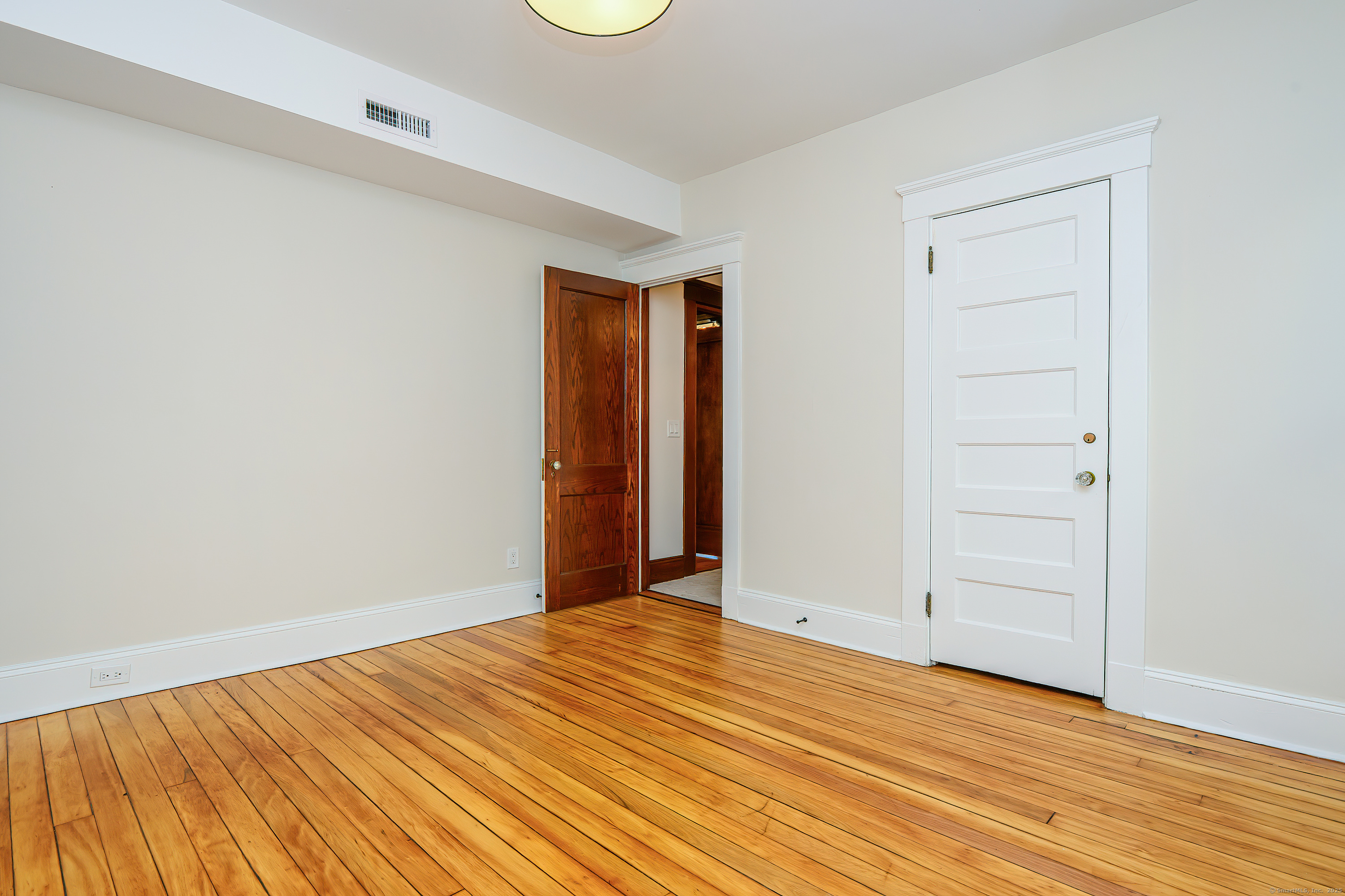 27 Hubinger Street, Unit 1 New Haven, CT 06511 - Photo 26 of 36 a view of empty room with wooden floor