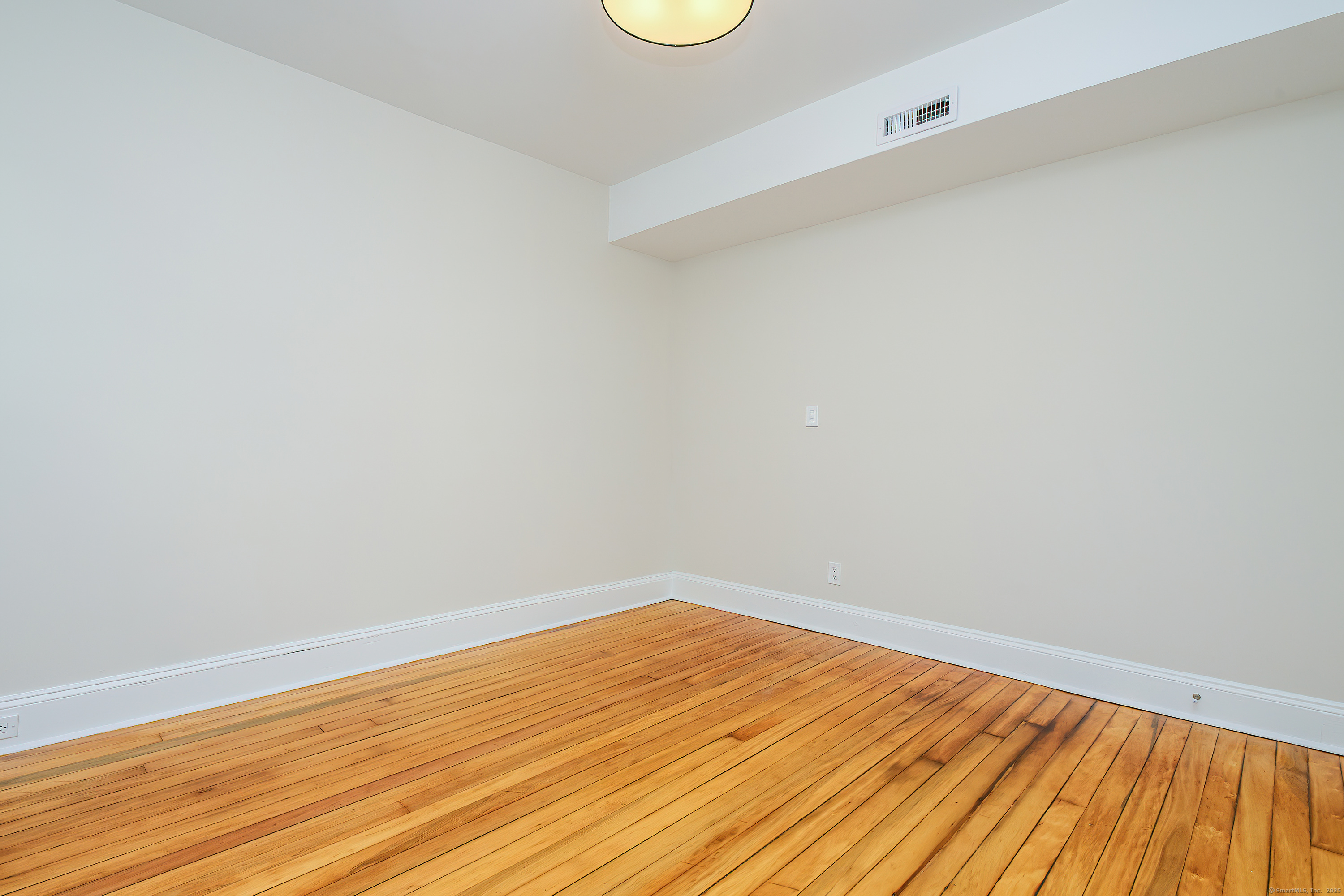 27 Hubinger Street, Unit 1 New Haven, CT 06511 - Photo 30 of 36 a view of an empty room with wooden floor