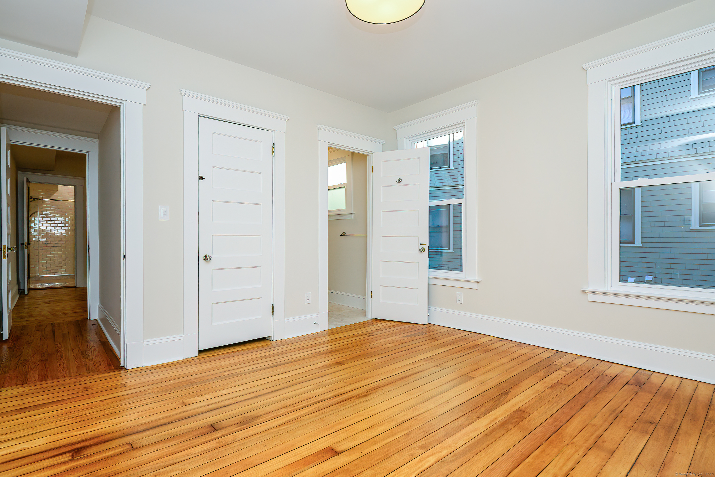 27 Hubinger Street, Unit 1 New Haven, CT 06511 - Photo 31 of 36 a bedroom with a bed and wooden floor