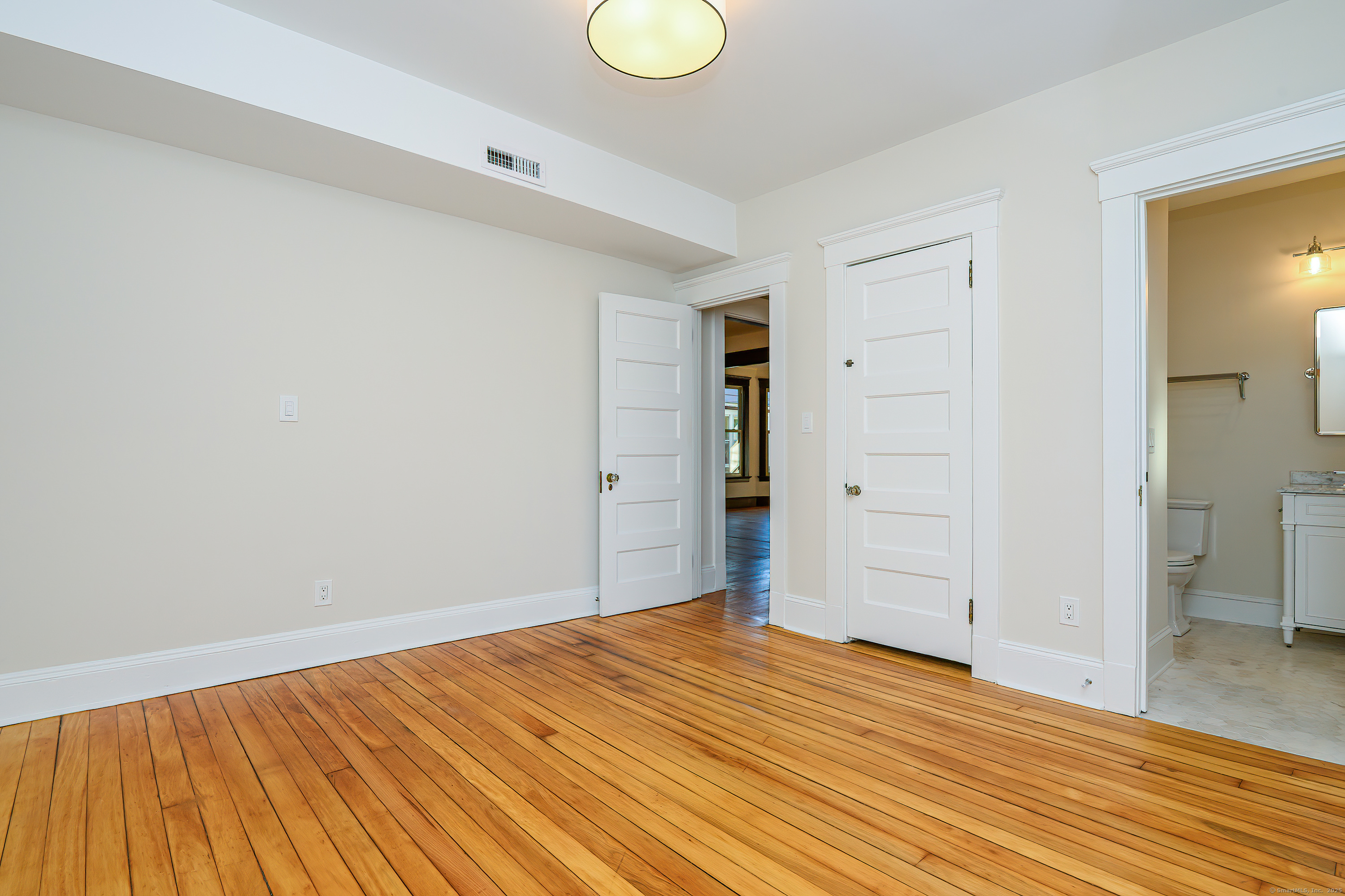 27 Hubinger Street, Unit 1 New Haven, CT 06511 - Photo 32 of 36 a view of empty room with wooden floor and fan
