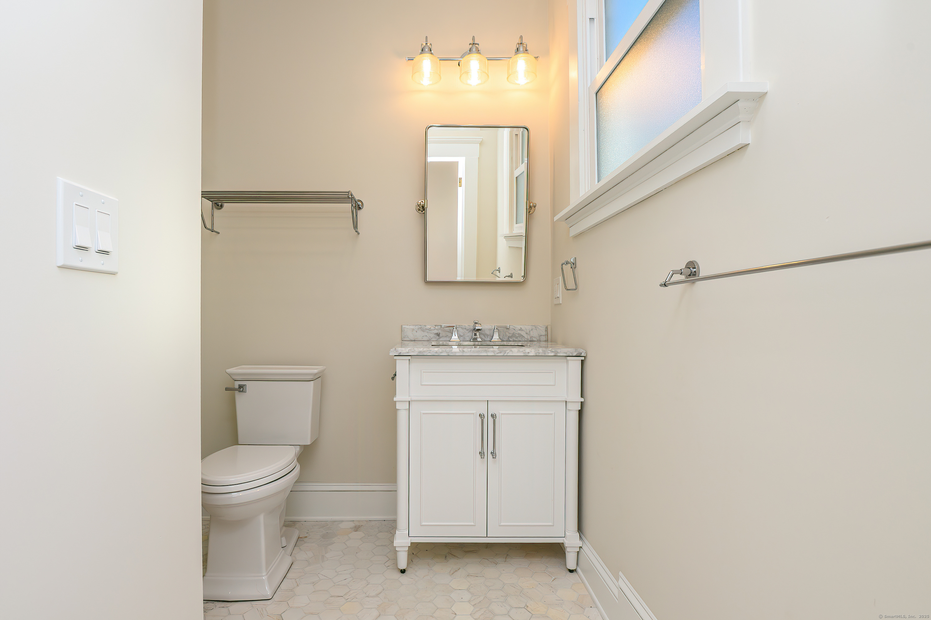 27 Hubinger Street, Unit 1 New Haven, CT 06511 - Photo 33 of 36 a bathroom with a toilet a sink and mirror