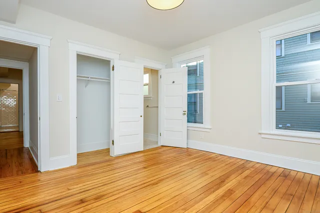 a big room with wooden floor and windows