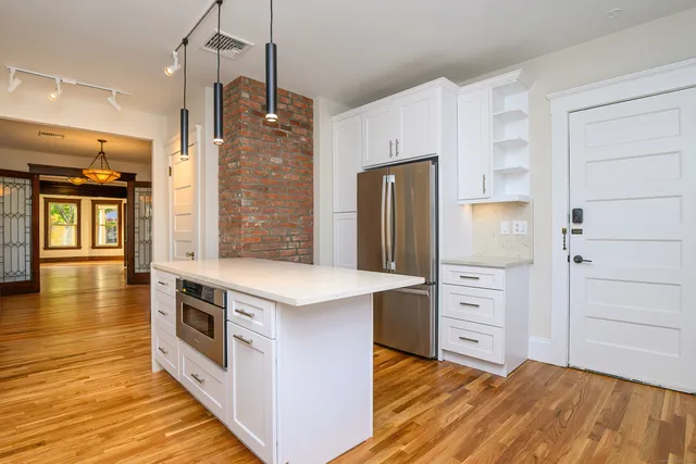 a kitchen with stainless steel appliances a stove and refrigerator