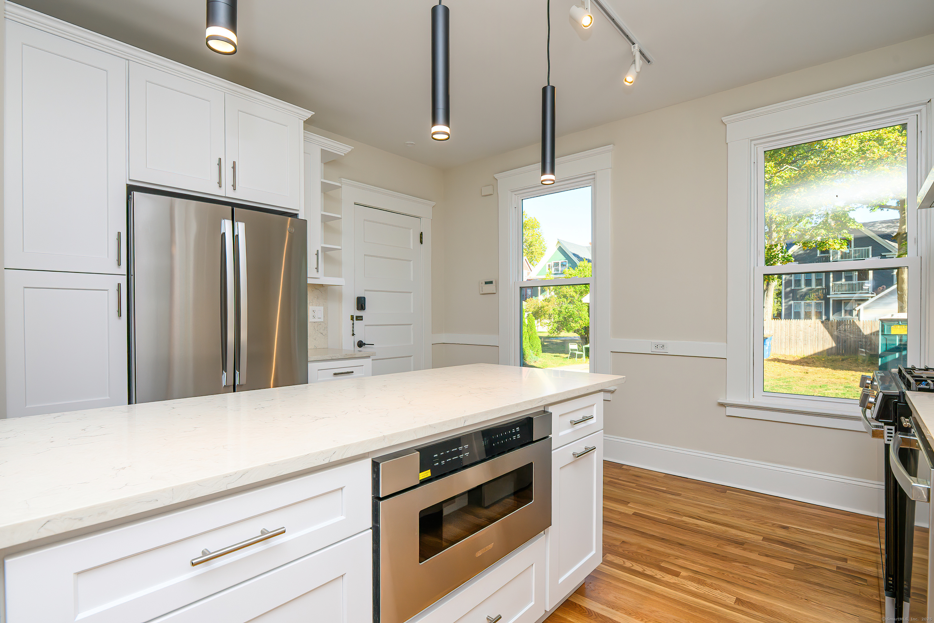 27 Hubinger Street, Unit 1 New Haven, CT 06511 - Photo 6 of 36 a kitchen with stainless steel appliances a stove a refrigerator and a window