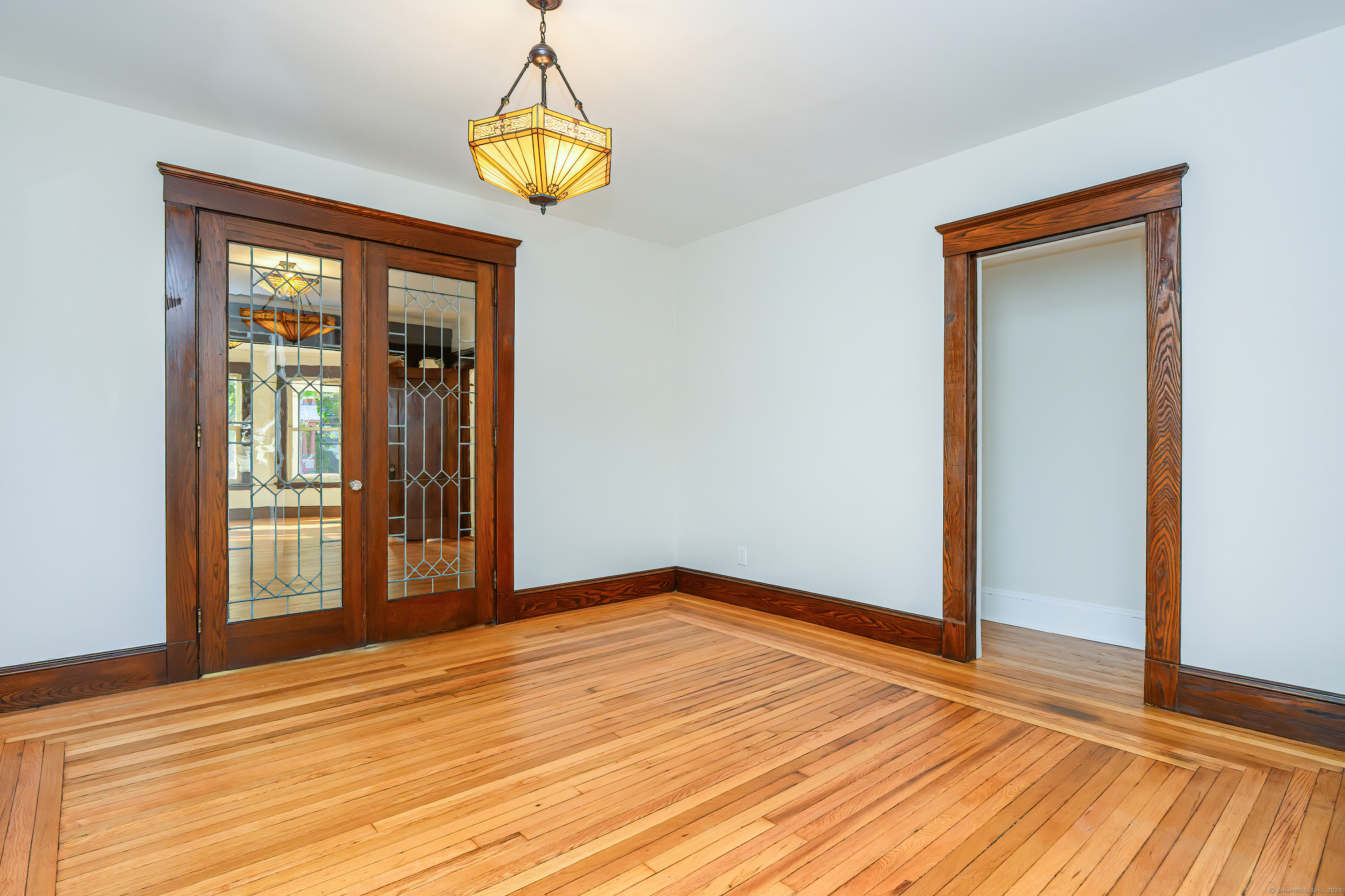 27 Hubinger Street, Unit 1 New Haven, CT 06511 - Photo 10 of 36 a view of empty room with wooden floor and fan
