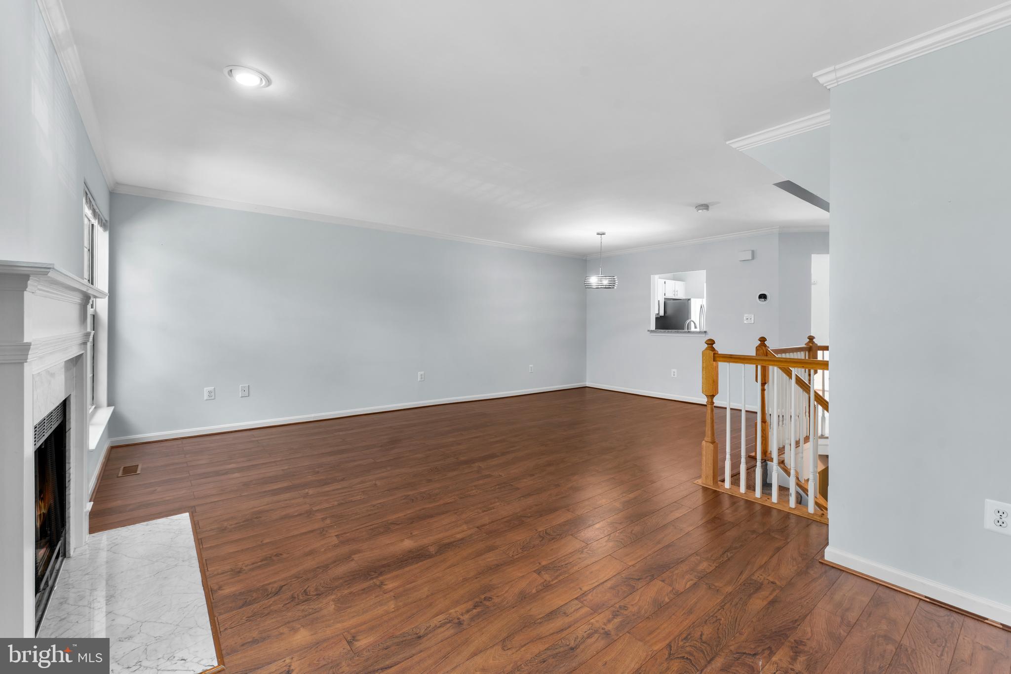 2204 Commissary Circle Odenton, MD 21113 - Photo 14 of 32 a big room with wooden floor fireplace and windows