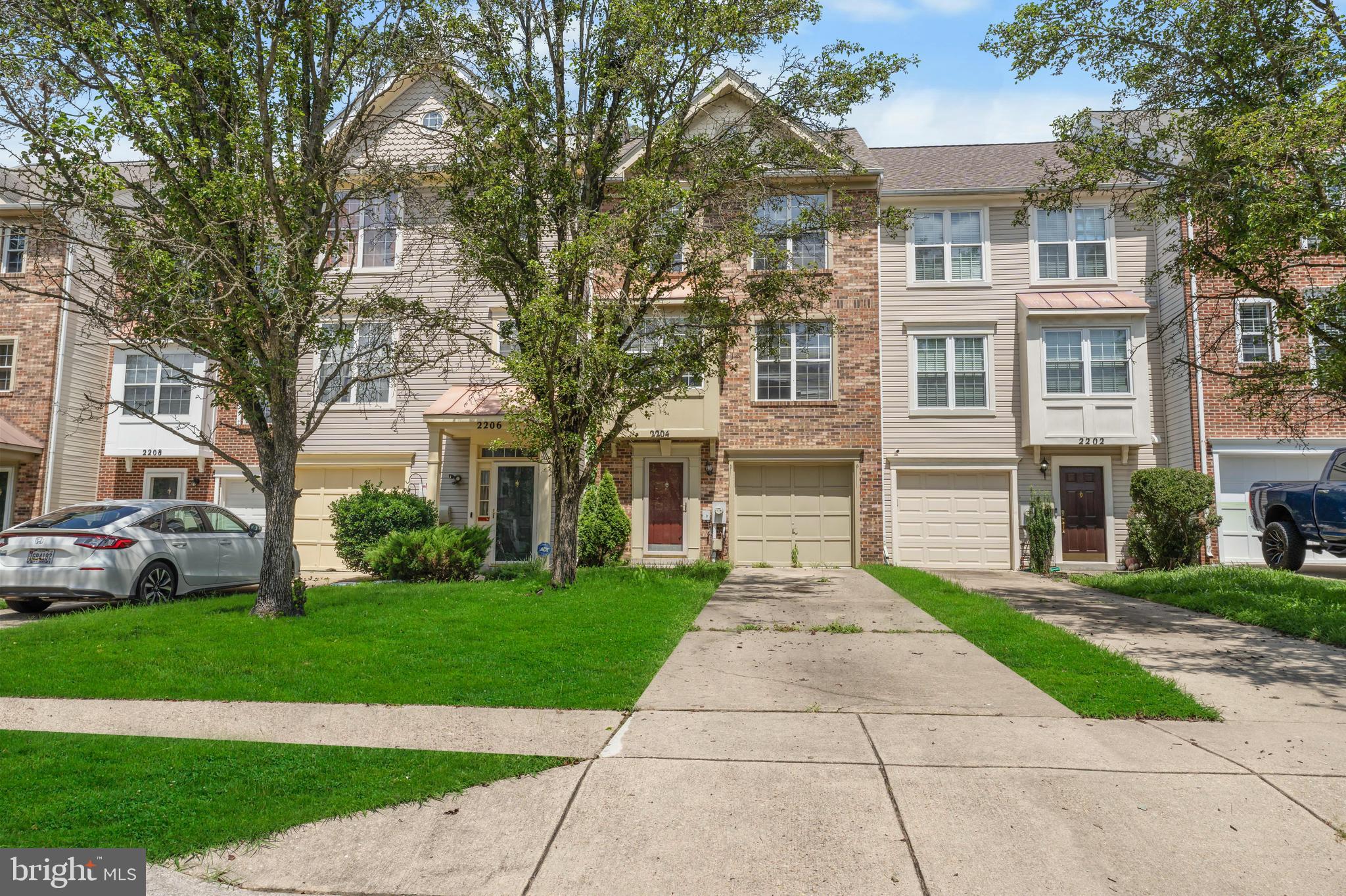 2204 Commissary Circle Odenton, MD 21113 - Photo 2 of 32 a front view of a house with a yard