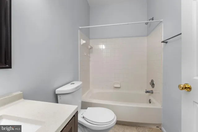 a bathroom with a toilet and a bathtub