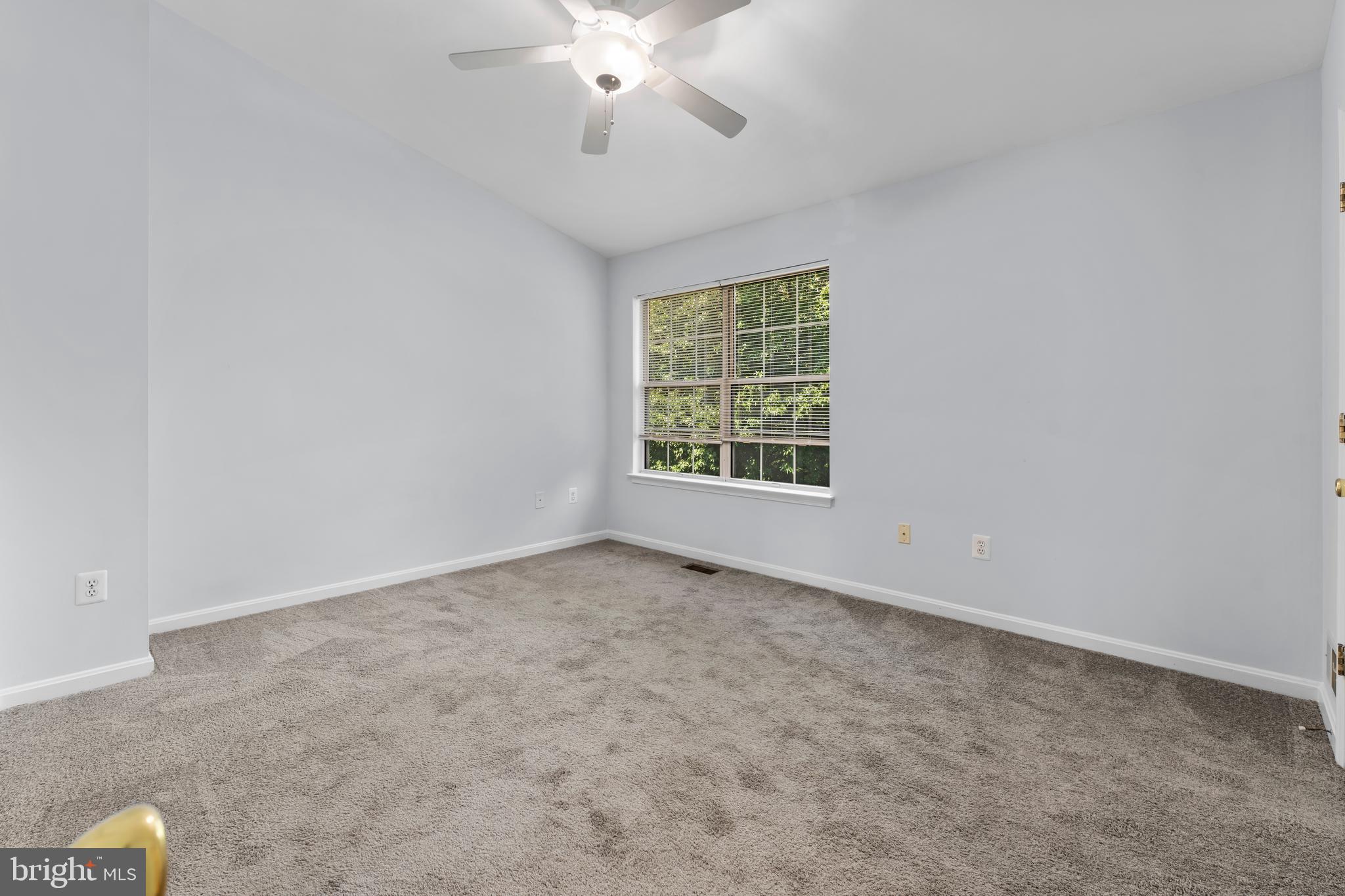 2204 Commissary Circle Odenton, MD 21113 - Photo 25 of 32 an empty room with a chandelier fan and windows