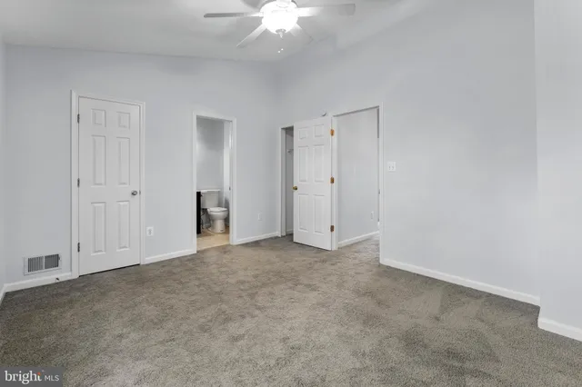 an empty room with a ceiling fan